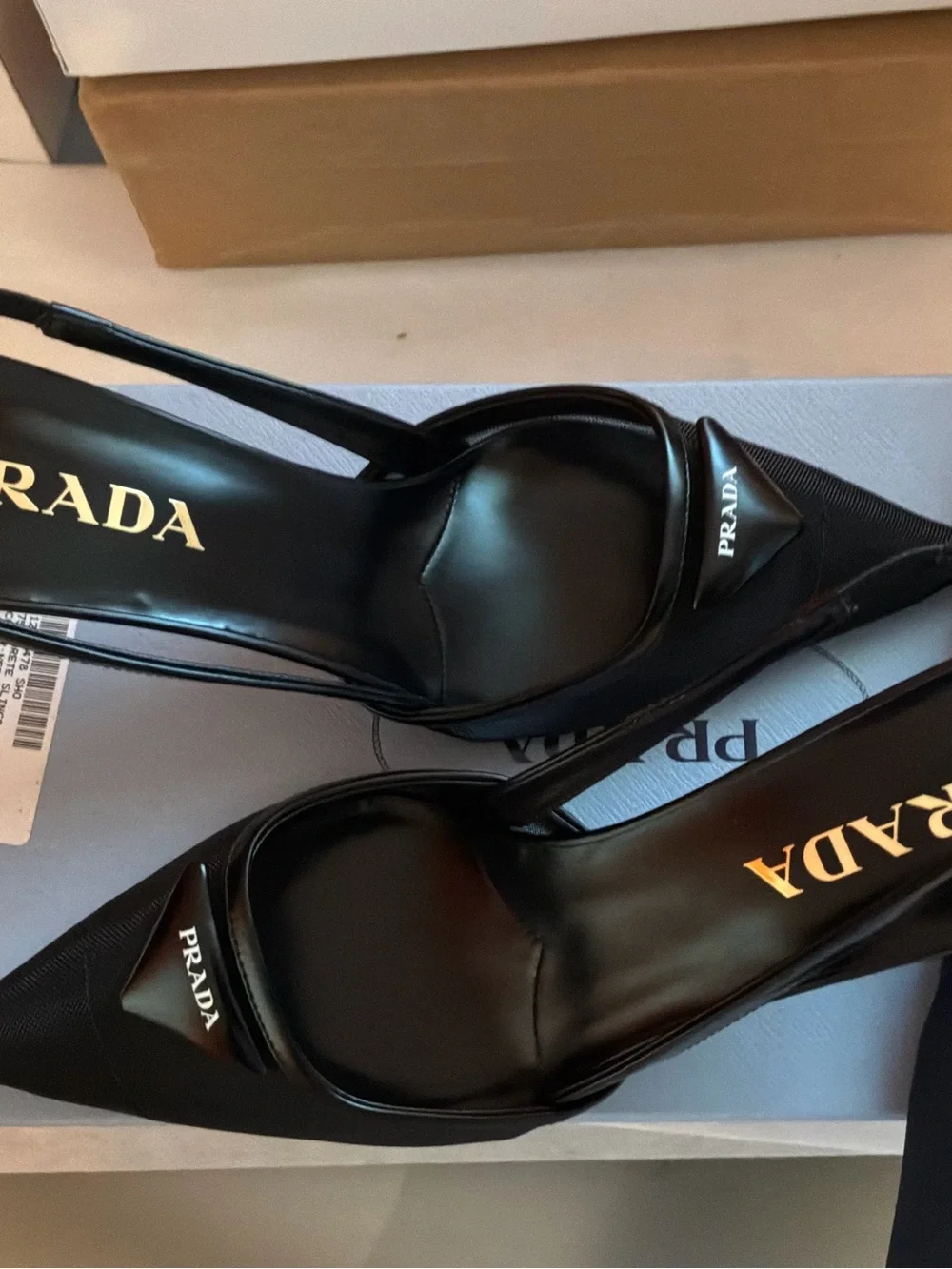 Prada Black Pointed Slingback Pumps with Logo Plaque